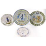 Four French faience cabinet plates and chargers, comprising an early 19thC Quimper plate, decorated