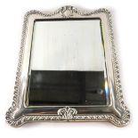 A George VI silver photograph frame, with an arched top, with Art Nouveau central panel and fluted o