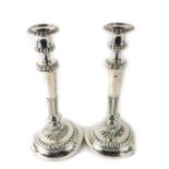 A pair of Victorian silver candlesticks, each with a tapered and fluted stem, on weighted base, make