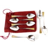 A set of six Elizabeth II silver teaspoons by Stuart Devlin, each with silver gilt floral top, on a