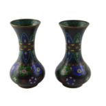 A pair of Oriental cloisonne vases, each decorated with roundels, leaves and flowers, in black, blue