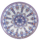 A large HB Quimper faience dished charger, in polychrome Imari type decoration, with blue and reds,