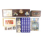 A group of collectors coin packs, framed space collectors coins, coin paperweights, collectors crown