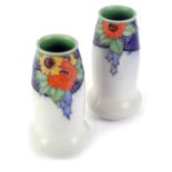 A pair of Royal Doulton stoneware vases, with tube lined decoration of orange, blue, green and yello