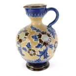 A Royal Doulton Slaters Patent jug or ewer, decorated with flowers and leaves with tube lining, on a