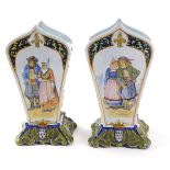 A pair of 19thC French faience vases, each of a crested shaped form, with armorial and painted figur
