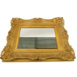 A gilt gesso rectangular wall mirror, the moulded frame decorated with shell, scrolls, etc., 73cm hi