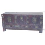 A Chinese low cabinet or sideboard, with arrangement of two pairs of panelled doors, and a central l