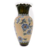 A Doulton Lambeth stoneware vase, with a flared blue and green glazed rim, and raised design of blue