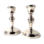 A pair of George V silver dwarf candlesticks, each of plain design on weighted base, Birmingham 1926