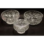 Three cut crystal glass fruit bowls, one with star design, 21cm wide, a highly fluted example, 19cm