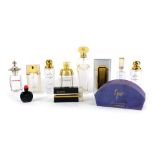 A group of empty perfume bottles, Champagne, So Pretty by Cartier, a small Joy Jean Patou, with part