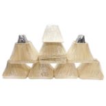 A collection of beige fabric covered rectangular lamp shades, and others.