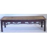 A Chinese narrow low opium or coffee table, the rectangular top with basket weave inset, above a pie