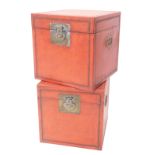 A pair of Chinese red painted vellum covered square boxes, each with brass lock plate and mechanism,