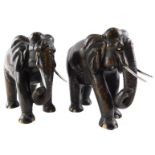 A pair of ebony carved elephants, each with bone inlaid eyes and feet and white metal tusks, 18cm hi