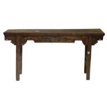 A Chinese altar table, the rectangular top with a carved frieze, on moulded end supports, 62cm high,