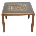 A 1960s/70s teak square coffee table, the top inset with a ceramic tile design, in shades of brown,