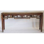 A Chinese red stained altar table, the frieze decorated with leaf carving, on plain supports, 88cm h