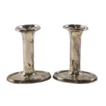 A pair of George V silver candlesticks, each on oval bases, loaded b. Birmingham 1913, 10cm high.