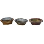 Three similar Chinese wash bowls, each with coopered bands, the largest 53cm wide. (AF)