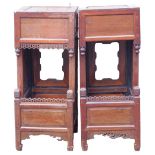 Two similar Chinese side cabinets or urn tables, each with a frieze drawer and a recess, with carved