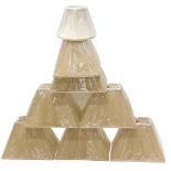 A collection of beige coloured fabric lamp shades.