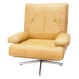 A 1960s/70s brown leather swivel armchair, with padded back and seat, on metal revolving X shaped ba
