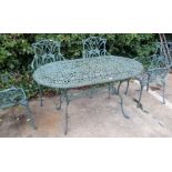 A Coalbrookdale style green garden table and four matching chairs.