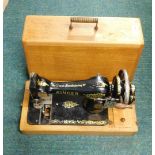 A cased Singer sewing machine.