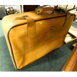 Two Antler tan suitcases.