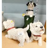 Two Scotty dog ornaments and a terrier in green boot.
