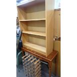 A beech effect three shelved bookcase, walnut console table, and a wine rack. (3)