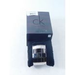 A Calvin Klein stainless steel ladies wristwatch, model K40211, with silvered finish, three row box