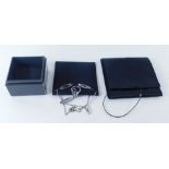 A Calvin Klein jewellery suite, comprising necklace, drop earrings and dress ring, each set in stain