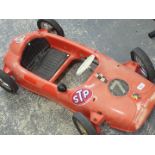 An STP child's red racing car.
