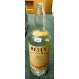 A large Bells Old Scotch Whisky empty bottle.