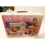 A Sew Real Tomy child's sewing machine, boxed.