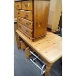 A pine extending kitchen table, chest of drawers, and two bed tables. (4)