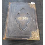A brass and leather bound Holy Bible.