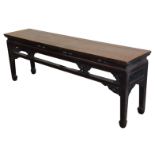 A Chinese hardwood rectangular low table, with a partially carved frieze, raised on square legs, 56c