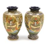 A pair of early 20thC Japanese Satsuma vases, of baluster form, decorated in enamels with reserves o