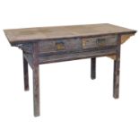 A Chinese hardwood side table, with two carved drawers, over a carved frame, raised on square legs,