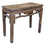 A Chinese elm side table, with a carved frieze, raised on square legs, 80cm high, 95cm wide, 46cm de