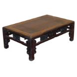 A Chinese hardwood occasional table, of rectangular section, with a carved frieze decorated with tre