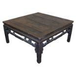 A Chinese hardwood occasional table, the top above a carved frieze, raised on square legs, 50cm high