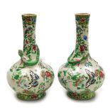 A pair of late 19thC Qing dynasty Cantonese famille rose pottery vases, of long necked bulbous form,
