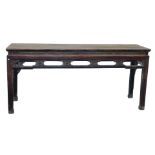 A Chinese hardwood side table, of rectangular section, above a foliate carved frieze, a further open