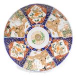 A Japanese Imari dish, decorated with reserves of geishas, and goldfish, 36cm wide.