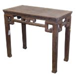 A Chinese elm side table, with a carved frieze, raised on square legs, 81cm high, 93.5cm wide, 46.5c